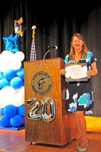 Jennifer Bond, Foundation co-president, holding one of the scholarship awards